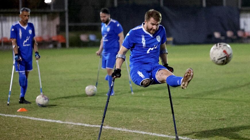 Ben Binyamin 29, shoots at goal during training with the Israeli amputee football team