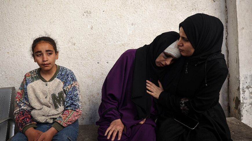 A Palestinian woman mourns her children killed in Israeli bombing in Rafah in the southern Gaza Strip