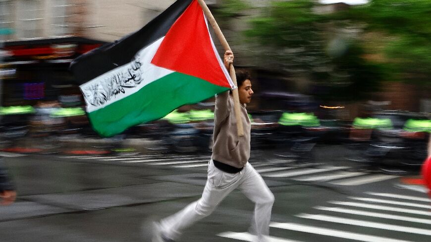 A pro-Palestinian demonstrator runs with a Palestinian flag during a rally in New York earlier this week