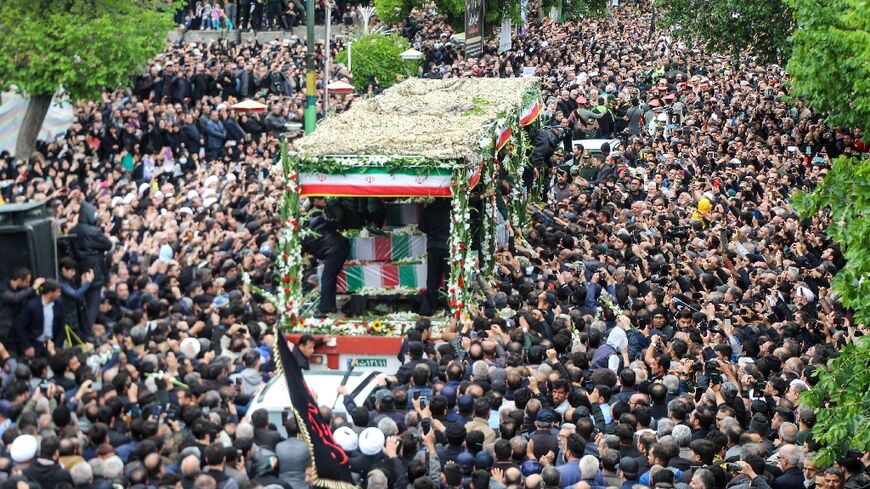 A truck carrying the bodies of Iranian president Ebrahim Raisi and seven members of his entourage winds its way through huge crowds in the northwestern city of Tabriz, where he was headed when he died in a Sunday helicopter crash