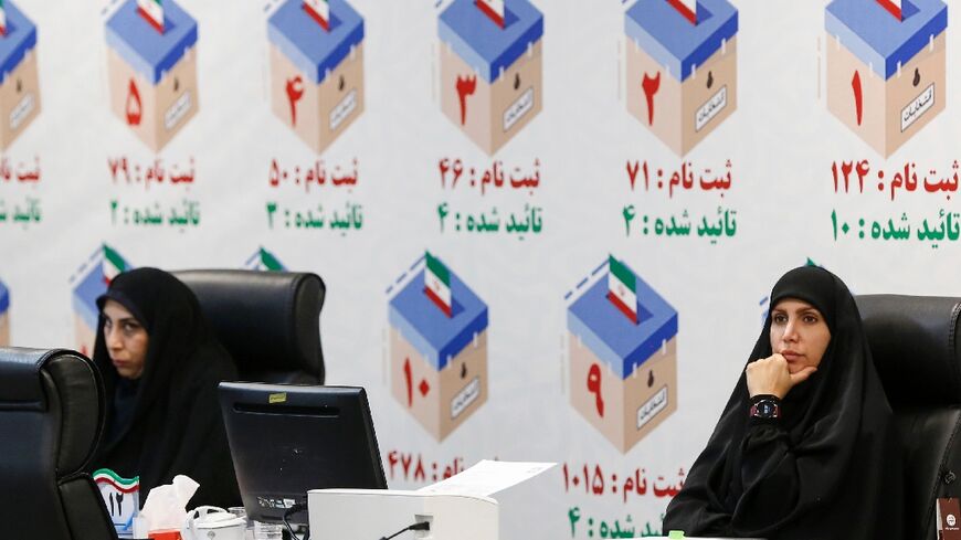 Iranian electoral officials at a registration office in Tehran ahead of snap elections following Ebrahim Raisi's death