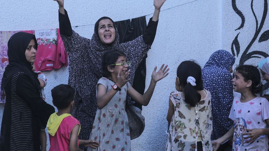 Palestinians react after an Israeli strike on Nuseirat refugee camp in central Gaza