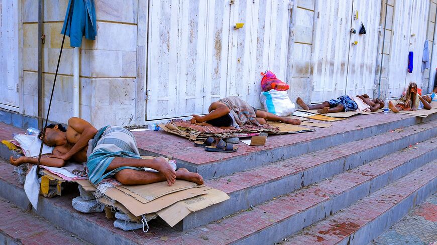Men sleep outside their homes because of the intense heat, in Yemen's Red Sea port city of Hodeida on July 21, 2023.