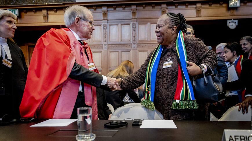 South African professor of International Law John Dugard and South African Minister of International Relations and Cooperation Naledi Pandor (R) arrive at the International Court of Justice (ICJ) prior to the verdict announcement in the genocide case against Israel, brought by South Africa, in The Hague on January 26, 2024. The top UN court said Israel should do everything it could to prevent any acts of genocide in the Gaza Strip, in a highly anticipated ruling. Israel must do everything to "prevent the co