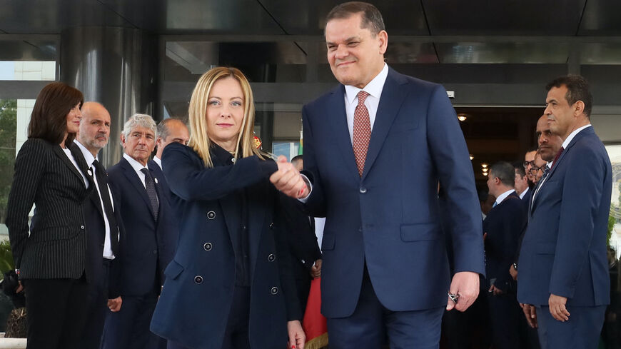 Libya's interim Prime Minister Abdulhamid Dbeibah (R) welcomes Italy's Prime Minister Giorgia Meloni as she arrives for a meeting in Tripoli on May 7, 2024. 