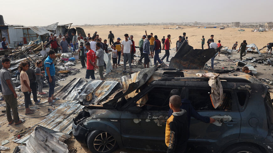 Palestinians gather at the site of an Israeli strike on a camp for internally displaced people, amid ongoing battles between Israel and Hamas, Rafah, Gaza Strip, May 27, 2024.