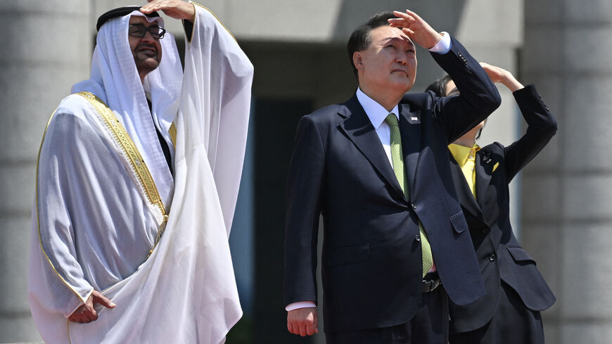 United Arab Emirates' President Sheikh Mohamed bin Zayed Al-Nahyan (L), South Korea's President Yoon Suk Yeol (C), and his wife Kim Keon Hee (R) watch the Black Eagles, the aerobatic team of T-50 jets belonging to South Korea's air force, during a welcoming ceremony at the Presidential Office in Seoul on May 29, 2024. (Photo by JUNG YEON-JE / POOL / AFP) (Photo by JUNG YEON-JE/POOL/AFP via Getty Images)