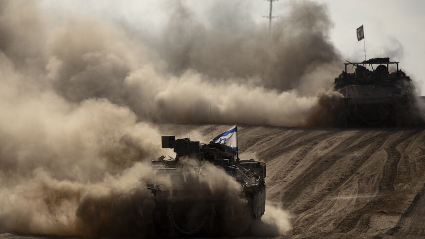 Israeli armored personnel carriers move along the border with the Gaza Strip on May 29, 2024 in southern Israel.