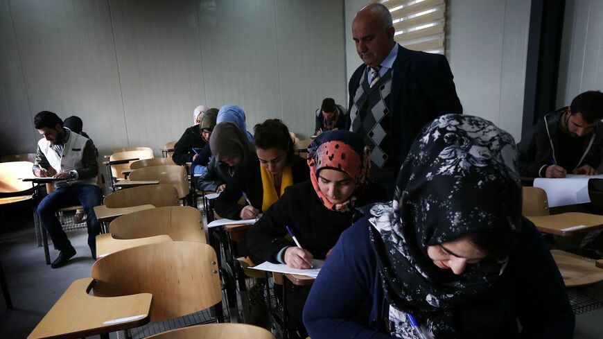 Iraqi displaced students, who fled clashes between pro-government forces and Islamic State (IS) group jihadists, sit in a classroom at the Hamdaniya University for internally displaced people on Jan. 31, 2016, in Arbil, in Iraq's autonomous Kurdish region.