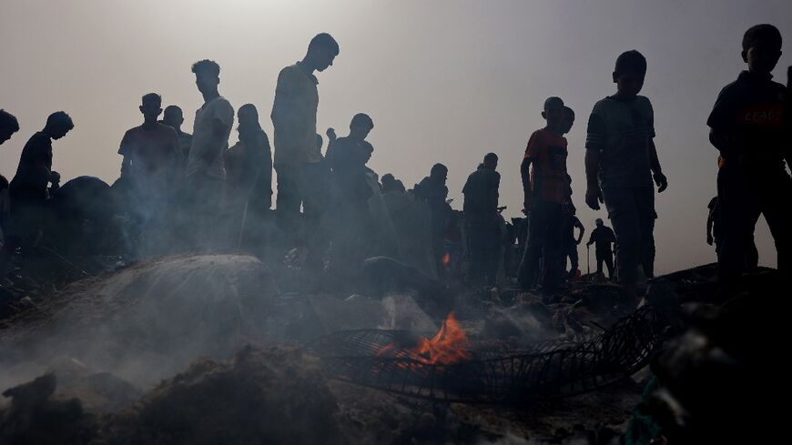 Palestinians gather at the site of an Israeli strike on a camp for internally displaced people in Rafah on May 27, 2024