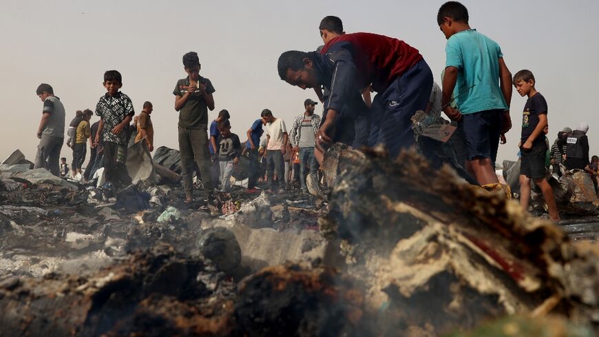 Palestinians gather at the site of an Israeli strike on a camp for internally displaced people in Rafah on May 27, 2024