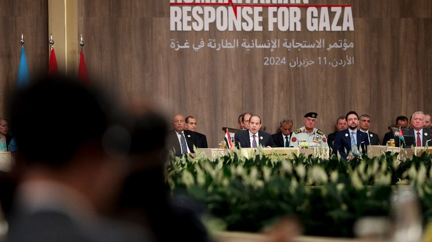 Jordan's King Abdullah II (right) takes part in an emergency summit on Gaza aid in Sweimeh on the shores of the Dead Sea in Jordan