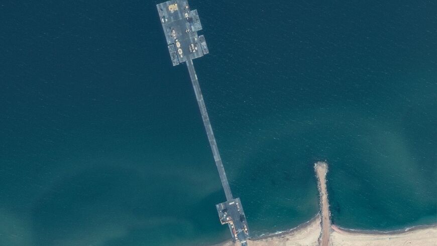 A handout satellite image courtesy of Maxar Technologies shows the US-built temporary aid pier on the Gaza coast on May 18, 2024
