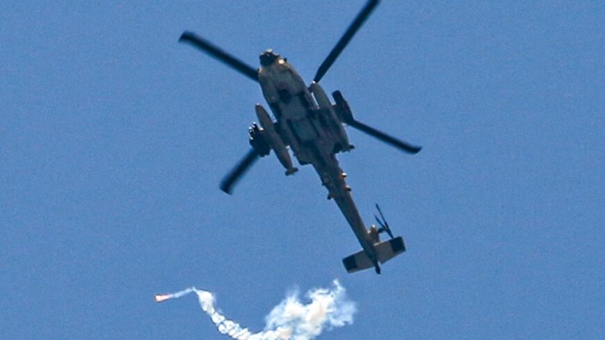 An Israeli attack helicopter fires flares over northwest Rafah on June 24, 2024