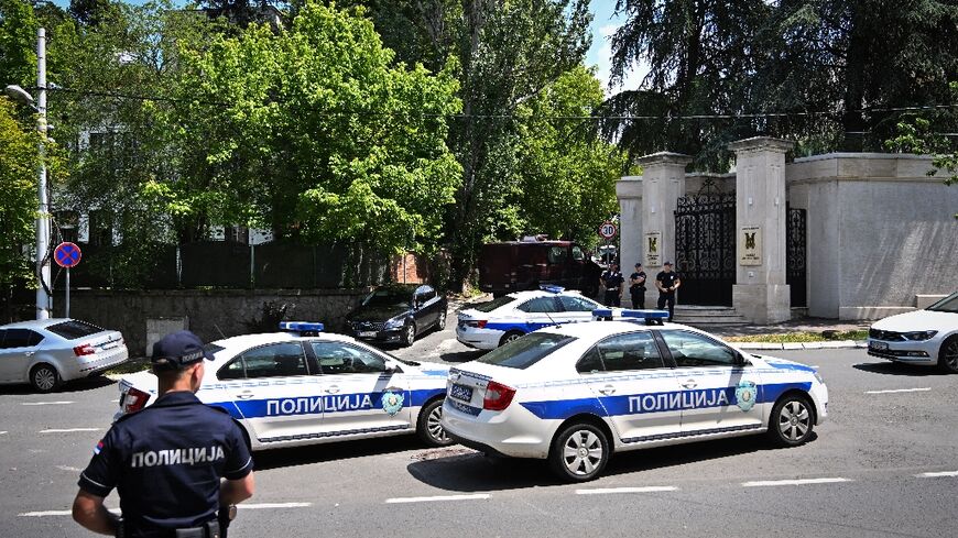 The assailant shot a police officer in the neck with a crossbow while he was on duty in front of the embassy in Belgrade
