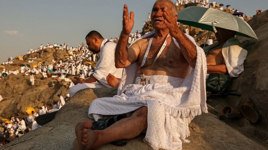 Muslim pilgrims pray at dawn on Saudi Arabia's Mount Arafat