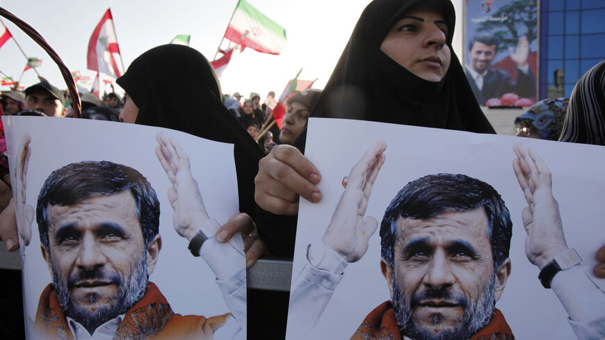 BEIRUT, LEBANON - OCTOBER 13: Lebanese people wave flags and hold portraits of Iranian President Mahmoud Ahmadinejad (not pictured) as he arrives in southern suberb of Beirut on October 13, 2010 in Lebanon. The controversial visit is seen as a boost for key ally Hezbollah. According to reports Mr Ahmadinejad may visit the border with Israel - the site of recent deadly clashes between Israeli and Lebanese forces. (Photo by Salah Malkawi/Getty Images)