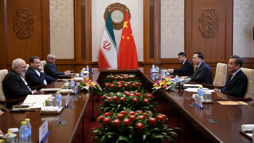 BEIJING, CHINA - DECEMBER 31: China's Foreign Minister Wang Yi talks to Iran's Foreign Minister Mohammad Javad Zarif during a meeting at the Diaoyutai state guest house on December 31, 2019 in Beijing, China. (Photo by Noel Celis - Pool/Getty Images)