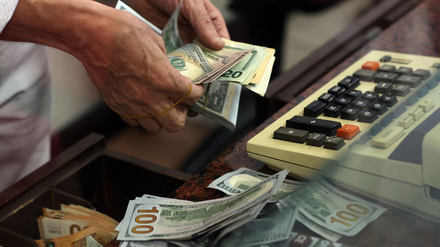 A teller counts US dollar bills at an exchange office in Ankara, Turkey, July 20, 2023.