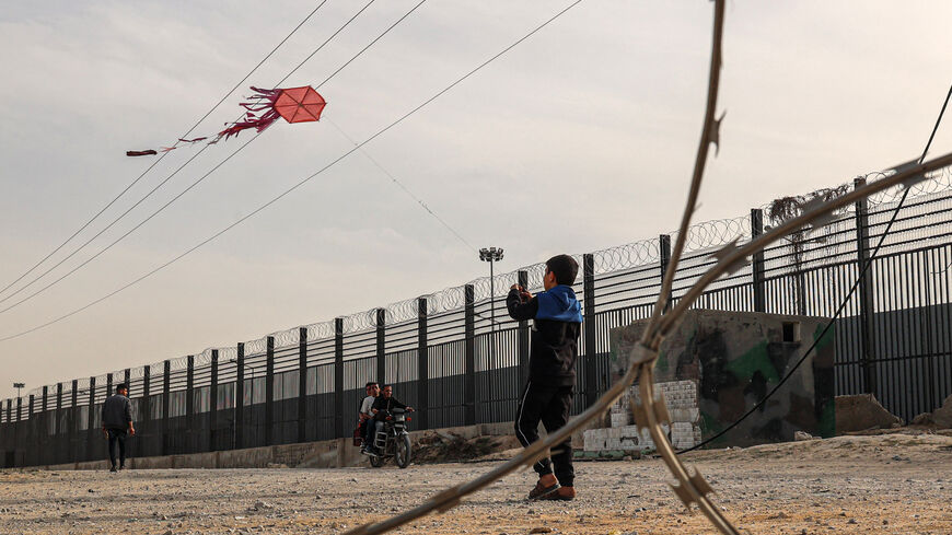 A displaced Palestinian child flies a kite near the border with Egypt in Rafah in the southern Gaza Strip on March 28, 2024, amid the ongoing conflict between Israel and Hamas militants. (Photo by SAID KHATIB / AFP) (Photo by SAID KHATIB/AFP via Getty Images)