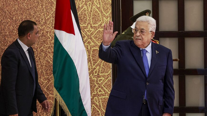 Palestinian Authority President Mahmud Abbas waves during a swearing-in ceremony of newly appointed ministers, on March 31, 2024, in Ramallah, in the occupied West Bank. 