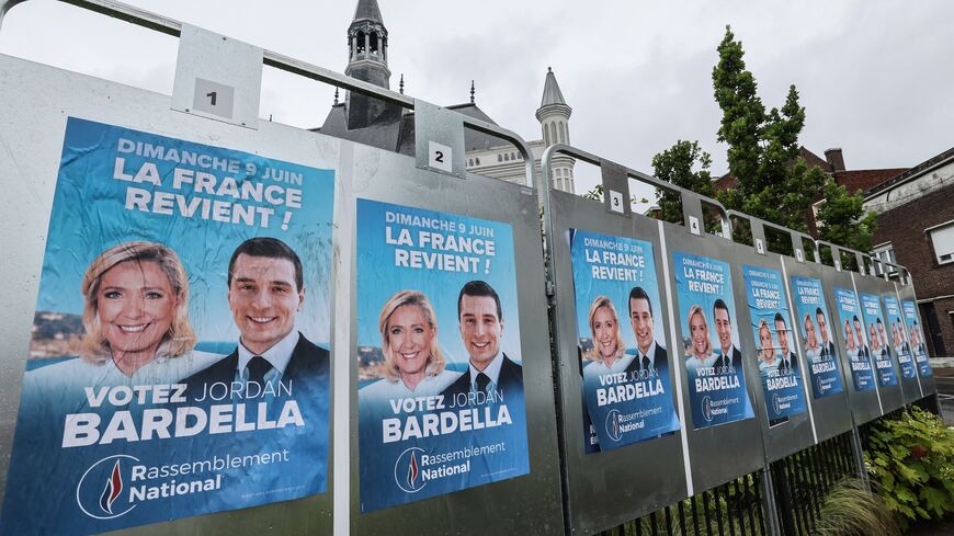 Electoral posters of Rassemblement National (RN) party with the pictures of Marine Le Pen (L) and Jordan Bardella are seen pasted on in Henin-Beaumont on June 10, 2024, a day after the European elections. 