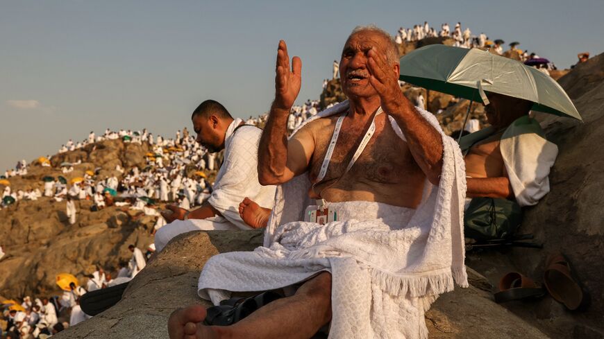 Muslim pilgrims pray at dawn on Saudi Arabia's Mount Arafat, also known as Jabal al-Rahma or Mount of Mercy, during the climax of the Hajj pilgrimage on June 15, 2024.
