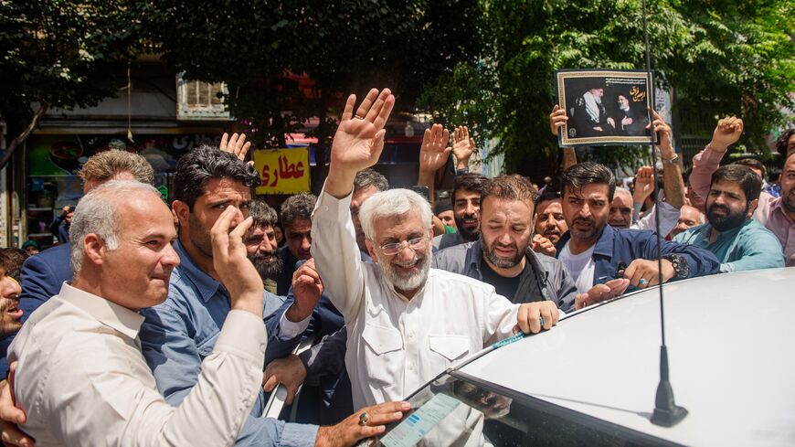 Saeed Jalili, ultraconservative former nuclear negotiator and Iran's presidential candidate, waves to the crowd after casting his vote at a polling station in Tehran during Iran's presidential election on June 28, 2024. 