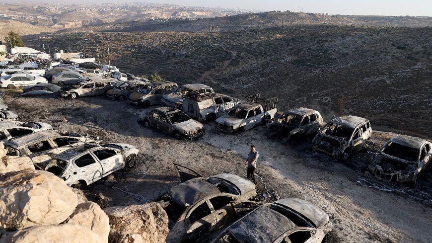 Rows of burnt out vehicles line a car park in the West Bank town of Burqah, after an arson attack by Jewish settlers
