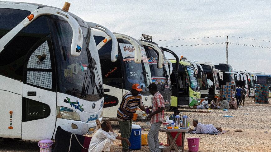 Sudanese drivers rest on May 14, 2023 after transporting evacuees from Sudan into Egypt, in Wadi Karkar village near Aswan.
