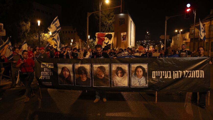 People gather near the home of Israeli Prime Minister Benjamin Netanyahu during an anti-government protest calling for the return of the hostages being held in the Gaza Strip