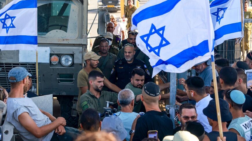 Israelis demonstrate next to the Sde Teiman military base near Beersheba, after nine soldiers were held for questioning, the army said, in a case of suspected abuse of a detainee