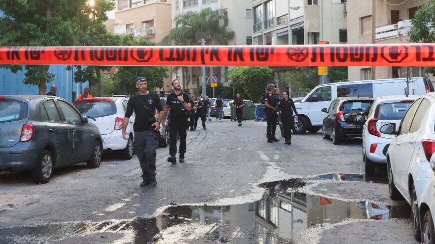 Israeli police inspect the site of a blast in Tel Aviv after Yemen's Iran-backed Huthis claimed a drone attack