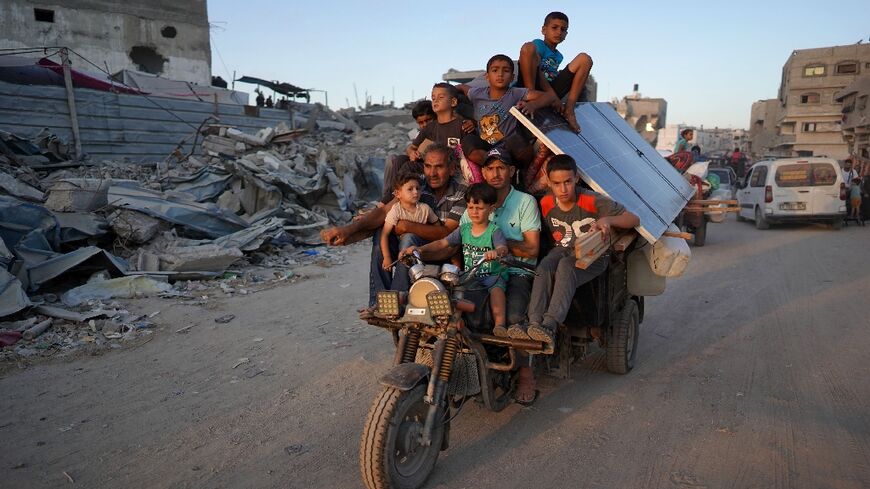 Displaced Palestinians leave east Khan Yunis after the Israeli army issued a new evacuation order in Gaza