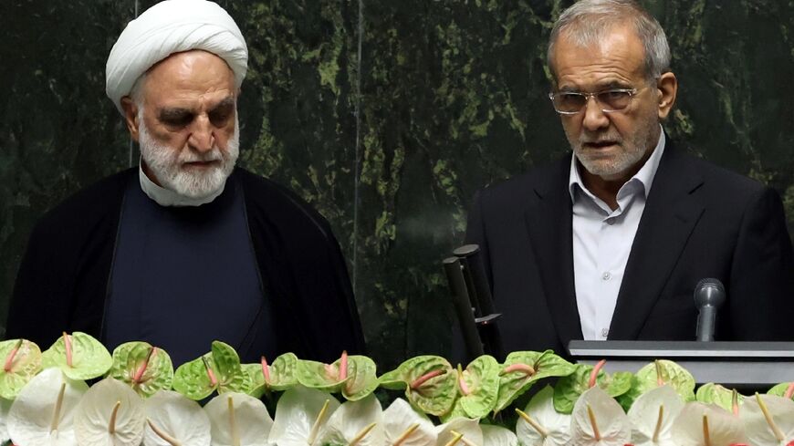 New Iranian President Masoud Pezeshkian (R) was sworn in by parliament on July 30, 2024