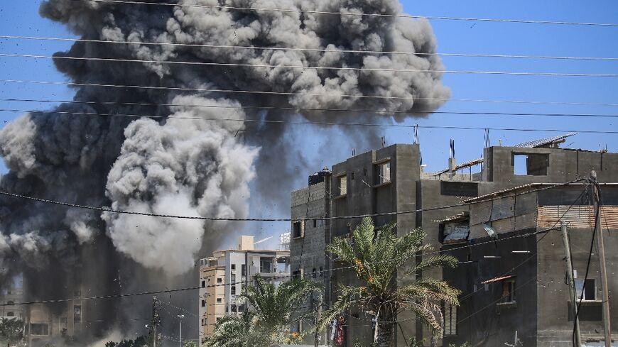 Smoke rises from a building hit by an Israeli strike in Nuseirat in the central Gaza Strip on July 20, 2024