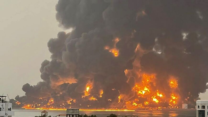A picture released by the Huthis shows flames and smoke rising over the rebel-held Yemeni port of Hodeida after an Israeli strike