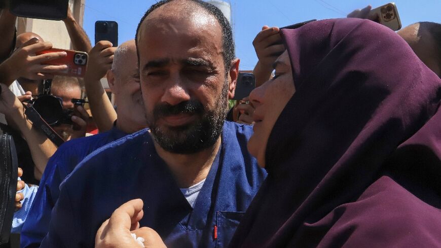 Al-Shifa hospital director Mohammed Abu Salmiya is welcomed by relatives