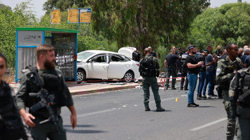 Israeli security forces cordon off the scene after police said a car rammed four soldiers at a bus stop near a military base