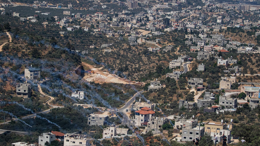 A view of Beita town with smoke from the teargas cannister fired by Israeli soldiers during an intervention in the clashes between Palestinians and Israeli settlers who stormed the top of Mount Al-Arma in Beita town, south of Nablus on Friday, May 03, 2024. The tensions have been rising in the areas of West Bank between the Palestinians and Israelis since October 07, and often the Israeli police intervene by firing teargas, and sending armed forces to disperse the Palestinians gathered to confront the Israe