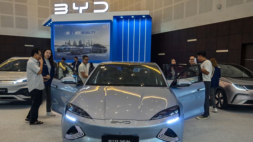 People visit the booth of Chinese automobile manufacturer BYD during the Indonesia International Motor Show in Surabaya on May 29, 2024. 