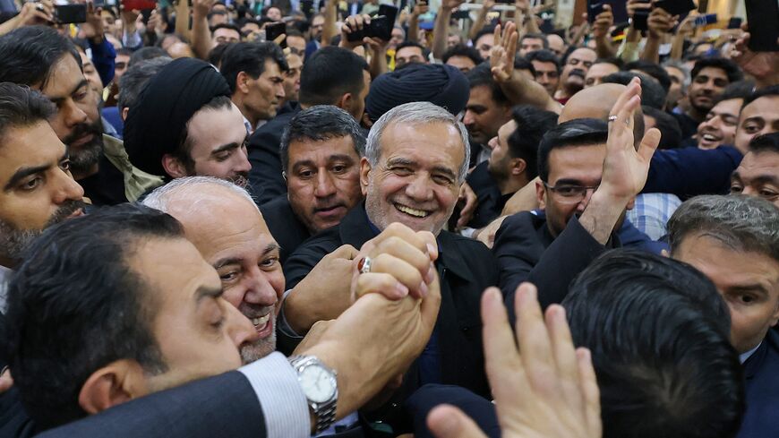 Supporters cheer as newly elected Iranian President Masoud Pezeshkian arrives at the shrine of the Islamic Republic's founder Ayatollah Ruhollah Khomeini in Tehran on July 6, 2024. 