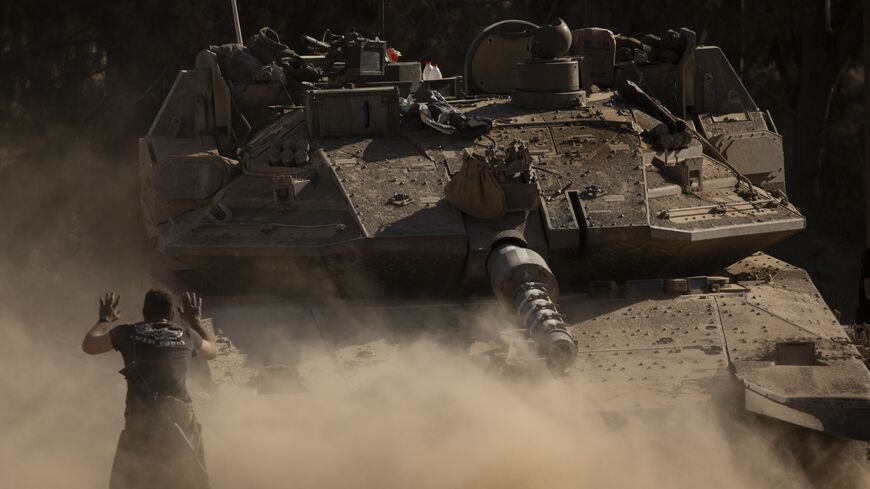 An Israeli soldier directs a tank near the border with the Gaza Strip on July 8, 2024, in southern Israel.