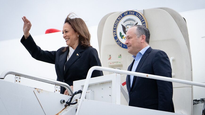 US Vice President Kamala Harris and second gentleman Douglas Emhoff descend from Air Force Two at Delaware National Air Guard base in New Castle, Delaware, on July 22, 2024.