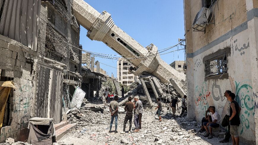 Palestinians inspect a minaret toppled by Israeli bombardment of Nuseirat refugee camp in central Gaza