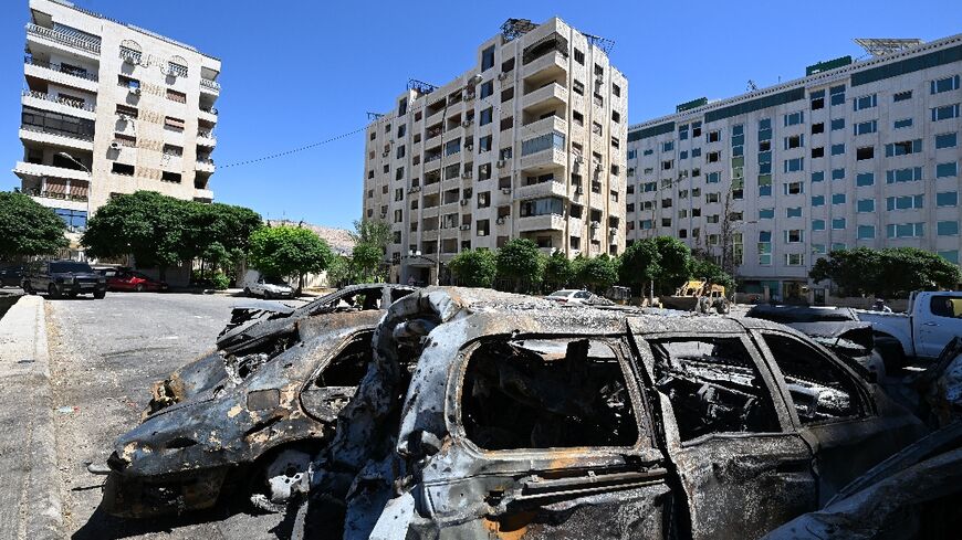 Charred cars in a parking lot after an Israeli strike on Damascus's Kafr Sousa district