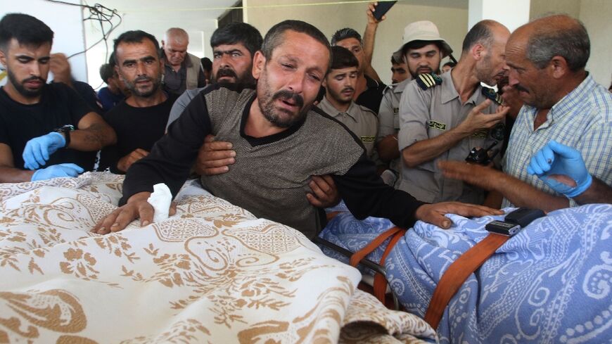 Relatives and friends mourn over the bodies of three children killed in strikes blamed on Israel