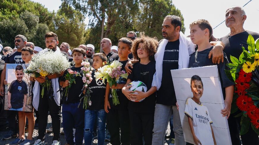 Mourners at the funeral of one of 12 Druze youths killed when a rocket hit a football pitch in the Israeli-annexed Golan Heights