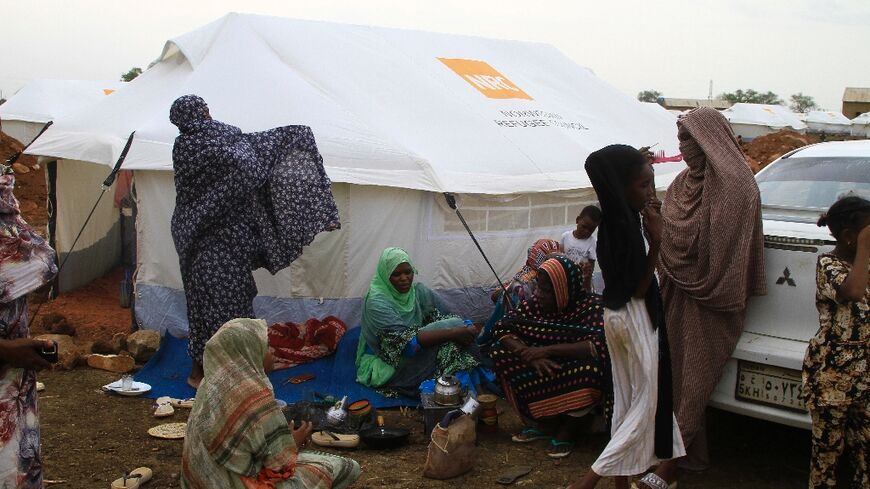 Women and children outside their tent at a camp for internally displaced at Gedaref in east Sudan
