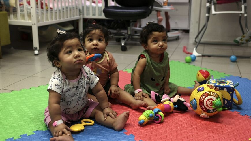 Palestinian triplets Najmeh, Najoua and Noor Bayouk have not seen their mother Hanane since shortly after their birth in August last year. The war that has engulfed her native Gaza has prevented her from returning to Jerusalem to pick them up